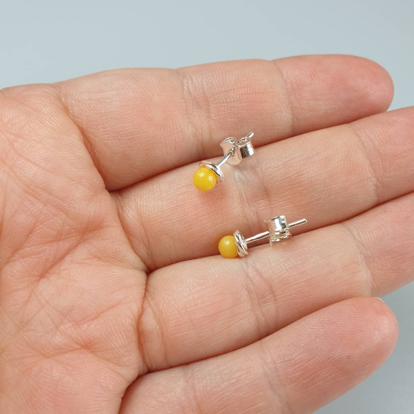 Minimalist amber earrings, small ear stud in the ear, white,